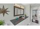 Elegant bathroom featuring a dark countertop and a large mirror at 602 84Th Nw St, Bradenton, FL 34209