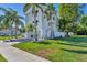 Two-story house with gray double garage doors, white siding, and palm trees at 602 84Th Nw St, Bradenton, FL 34209