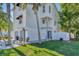 Two-story house with gray double garage doors, white siding, and palm trees at 602 84Th Nw St, Bradenton, FL 34209