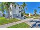 Two-story house with gray double garage doors, white siding, and palm trees at 602 84Th Nw St, Bradenton, FL 34209