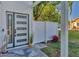 Modern front door with black accents and tropical plants at 602 84Th Nw St, Bradenton, FL 34209