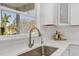 Modern kitchen sink with a sleek, gold faucet and white quartz countertops at 602 84Th Nw St, Bradenton, FL 34209