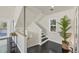 Modern staircase with dark hardwood floors and neutral walls at 602 84Th Nw St, Bradenton, FL 34209