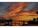 Spectacular sunset view over calm water with boats on a lift at 602 84Th Nw St, Bradenton, FL 34209