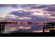 Stunning sunset over the calm water, with boats docked at a pier at 602 84Th Nw St, Bradenton, FL 34209