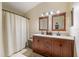 The bathroom features double sinks, framed mirrors, and a shower with curtain at 14847 Skip Jack Loop, Lakewood Ranch, FL 34202