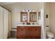 This bathroom features double sinks, a decorative vanity, and ample lighting at 14847 Skip Jack Loop, Lakewood Ranch, FL 34202