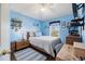 Bedroom with blue walls, wood floors, and a ceiling fan at 14847 Skip Jack Loop, Lakewood Ranch, FL 34202