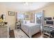 Bedroom with neutral walls, wood floors, and two windows at 14847 Skip Jack Loop, Lakewood Ranch, FL 34202