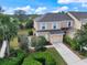 Beautiful two-story home with a manicured lawn, mature trees, and a welcoming two-car garage at 14847 Skip Jack Loop, Lakewood Ranch, FL 34202