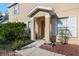 Inviting entryway features a covered porch, manicured garden, and a walkway leading to the front door at 14847 Skip Jack Loop, Lakewood Ranch, FL 34202