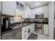 Beautiful kitchen showcasing stainless steel appliances, white cabinetry, and stylish backsplash at 14847 Skip Jack Loop, Lakewood Ranch, FL 34202