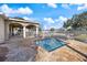 Pool area featuring a shallow pool and covered patio with tables and chairs in a secure environment at 14847 Skip Jack Loop, Lakewood Ranch, FL 34202