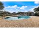 Community pool with a covered patio and lounge chairs on a brick deck, ideal for relaxation at 14847 Skip Jack Loop, Lakewood Ranch, FL 34202