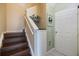 Elegant staircase with wood steps and white risers leading to the upper level of the home at 14847 Skip Jack Loop, Lakewood Ranch, FL 34202