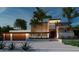 Modern home with wood and white accents, two-car garage, and palm trees at 109 N Warbler Ln, Sarasota, FL 34236