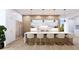 Modern kitchen with white cabinets, marble countertops, and island seating at 109 N Warbler Ln, Sarasota, FL 34236