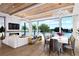 Open living and dining area with water views, fireplace, and chandelier at 109 N Warbler Ln, Sarasota, FL 34236