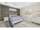 Serene bedroom with a white metal bed frame, gray bedding, and two white nightstands at 2129 Lorraine Dr, Port Charlotte, FL 33953