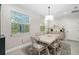 Dining area features a light wood table, six chairs, and a view to the backyard at 2129 Lorraine Dr, Port Charlotte, FL 33953