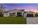 Modern home with gray siding, screened porch, and paver driveway at 2129 Lorraine Dr, Port Charlotte, FL 33953