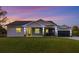 Modern home with gray siding, screened porch, and paver driveway at 2129 Lorraine Dr, Port Charlotte, FL 33953