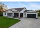 Modern one-story home with gray siding and black garage door at 2129 Lorraine Dr, Port Charlotte, FL 33953