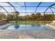 Enjoy this refreshing screened pool with a view of nature at 2129 Lorraine Dr, Port Charlotte, FL 33953