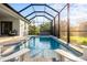 Inviting screened pool with spa and lush landscaping at 2129 Lorraine Dr, Port Charlotte, FL 33953