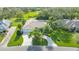 Bird's eye view of a house with a curved driveway and lush landscaping at 3017 Wilderness E Blvd, Parrish, FL 34219