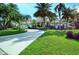 House with circular driveway, landscaping, and palm trees at 3017 Wilderness E Blvd, Parrish, FL 34219