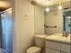 Bright bathroom featuring a vanity with marble countertop, toilet and walk in shower at 3993 Lake Bayshore Dr # F513, Bradenton, FL 34205