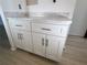 Bathroom vanity with white cabinets, marble countertop and chrome hardware at 3993 Lake Bayshore Dr # F513, Bradenton, FL 34205