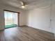 Bright bedroom featuring sliding glass doors to a balcony and ceiling fan at 3993 Lake Bayshore Dr # F513, Bradenton, FL 34205