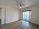 Bright bedroom featuring sliding glass doors to a balcony, ceiling fan and closet at 3993 Lake Bayshore Dr # F513, Bradenton, FL 34205