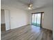 Bright bedroom featuring sliding glass doors to a balcony, ceiling fan and closet at 3993 Lake Bayshore Dr # F513, Bradenton, FL 34205