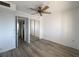 Bedroom featuring wood-look floors, closet with mirrored doors, and a ceiling fan at 3993 Lake Bayshore Dr # F513, Bradenton, FL 34205
