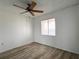 Bright bedroom featuring wood-look floors, ceiling fan, and a window at 3993 Lake Bayshore Dr # F513, Bradenton, FL 34205