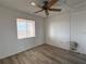 Bedroom featuring wood-look floors, ceiling fan, and a window with blinds at 3993 Lake Bayshore Dr # F513, Bradenton, FL 34205