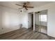 Bedroom features wood-look floors, closet with mirrored doors, and a ceiling fan at 3993 Lake Bayshore Dr # F513, Bradenton, FL 34205