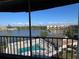 Breathtaking lake view from balcony overlooking the community pool and lush landscaping at 3993 Lake Bayshore Dr # F513, Bradenton, FL 34205
