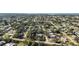 An aerial view of the neighborhood filled with mature trees and many single Gathering homes at 611 Mobile Rd, Venice, FL 34293