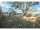 View of backyard with mature trees and view of home's screened pool at 611 Mobile Rd, Venice, FL 34293