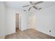 Bright bedroom features neutral walls, wood-look flooring, a ceiling fan and closet access at 611 Mobile Rd, Venice, FL 34293