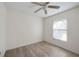 Bedroom features neutral walls, wood-look flooring, a ceiling fan and a window with blinds at 611 Mobile Rd, Venice, FL 34293