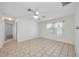 Bright bedroom features neutral walls, tile flooring, a ceiling fan and a window with sheer curtains at 611 Mobile Rd, Venice, FL 34293