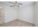 Bright bedroom features neutral walls, wood-look flooring, and a ceiling fan at 611 Mobile Rd, Venice, FL 34293