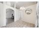 Dining area with tile floors, chandelier, and elegant mirror, connecting seamlessly to other rooms at 611 Mobile Rd, Venice, FL 34293