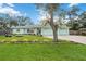 Charming home featuring a well-maintained lawn and a beautiful light green exterior at 611 Mobile Rd, Venice, FL 34293