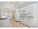 Bright kitchen featuring white appliances, plentiful cabinetry and seamless flow to adjacent areas at 611 Mobile Rd, Venice, FL 34293